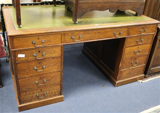 An Edwardian oak pedestal desk W.153cm